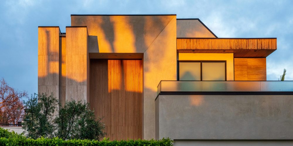 Modern home exterior with warm sunset reflections in West Hollywood, California.